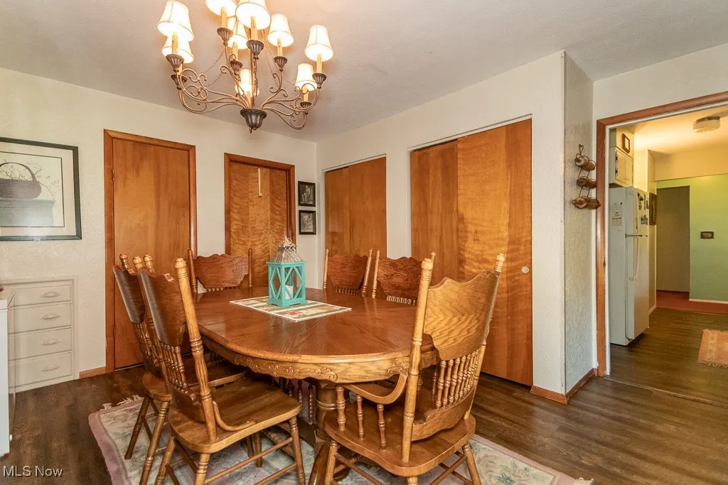 Dining area with a chandelier and wood finished floors