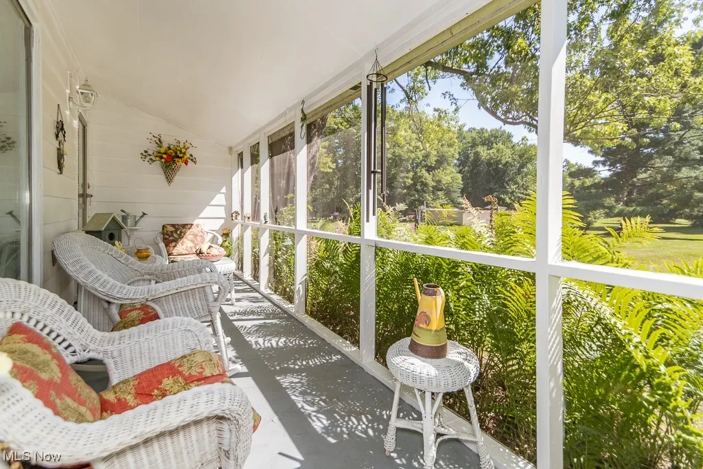 Sunroom featuring vaulted ceiling