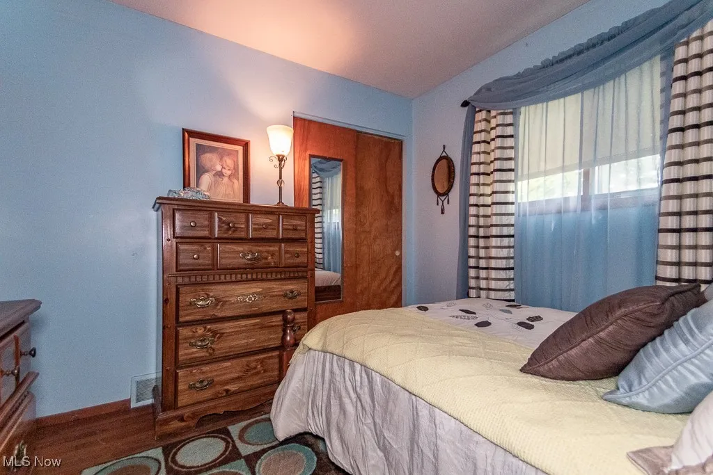 Bedroom with wood finished floors and baseboards