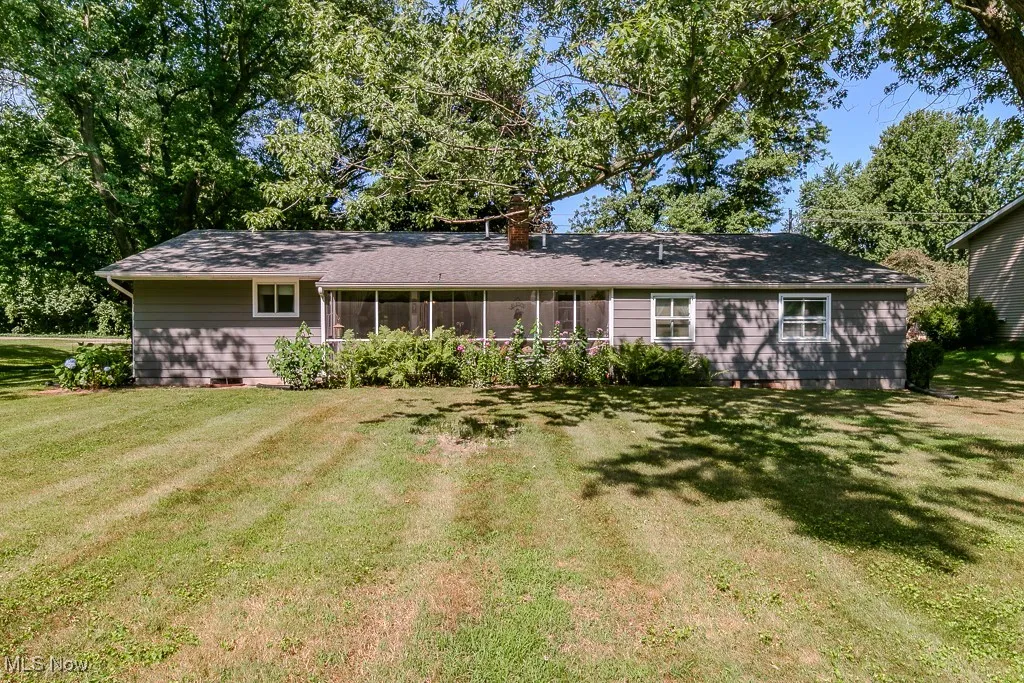 Ranch-style home with a sunroom and a back
lawn