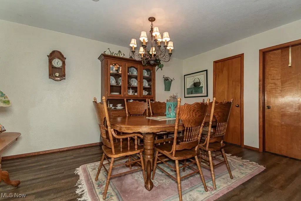 Dining area featuring a chandelier and wood finished floors