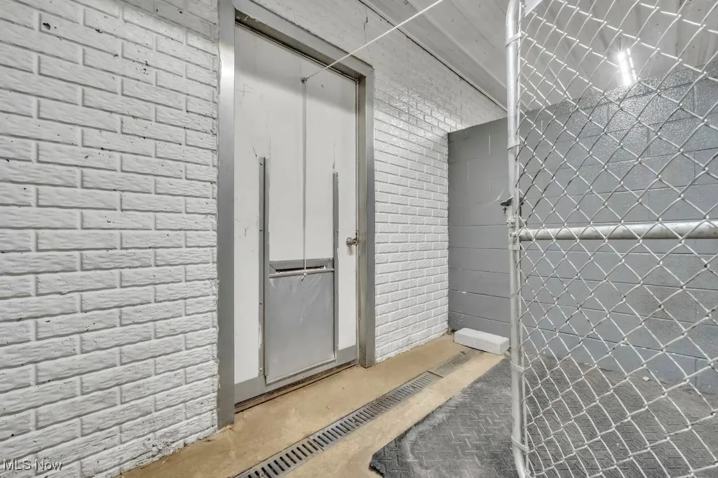 kennel interior with door and drain