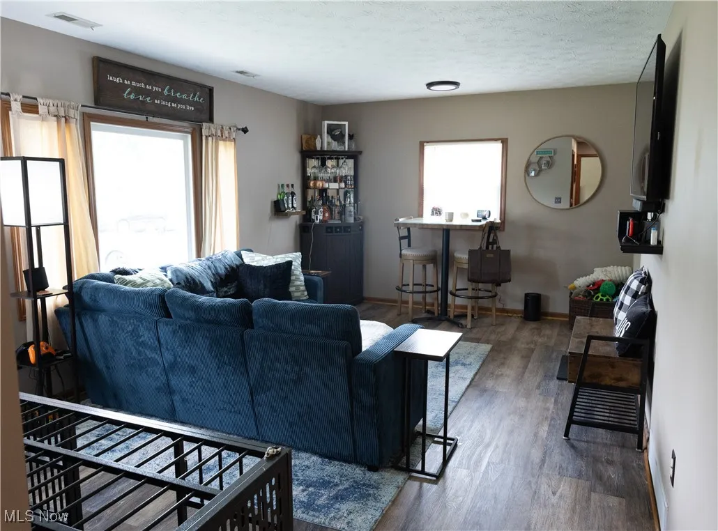 Living room featuring a textured ceiling and wood finished floors