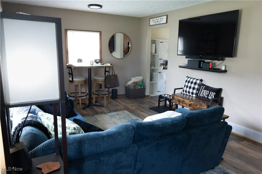 Living area with wood finished floors and baseboards