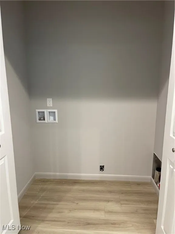 Laundry Closet featuring electric dryer hookup, light wood finished floors, and washer hookup