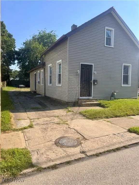 Rear view of property with a chimney and entry steps