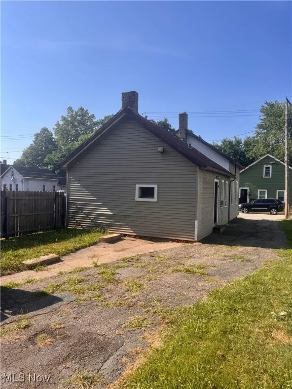 View of side of property with a chimney