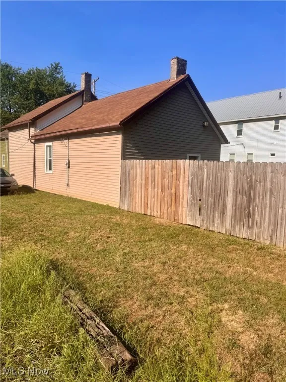 View of property exterior with a chimney