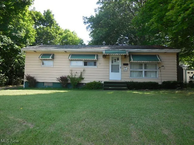 View of front of house with a front lawn and entry steps