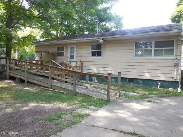 Back of house with a wooden deck
