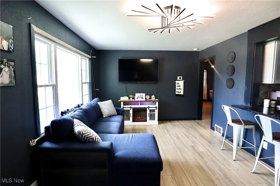 Living area featuring light wood-style floors and baseboards
