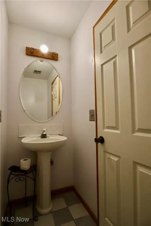 Bathroom featuring baseboards and tile patterned floors