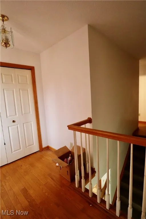 Stairway featuring hardwood / wood-style flooring and a textured ceiling