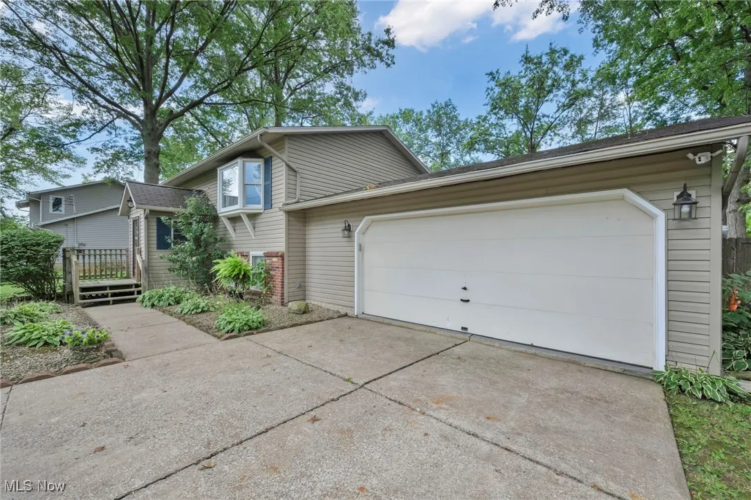 View of front facade with concrete driveway and a garage