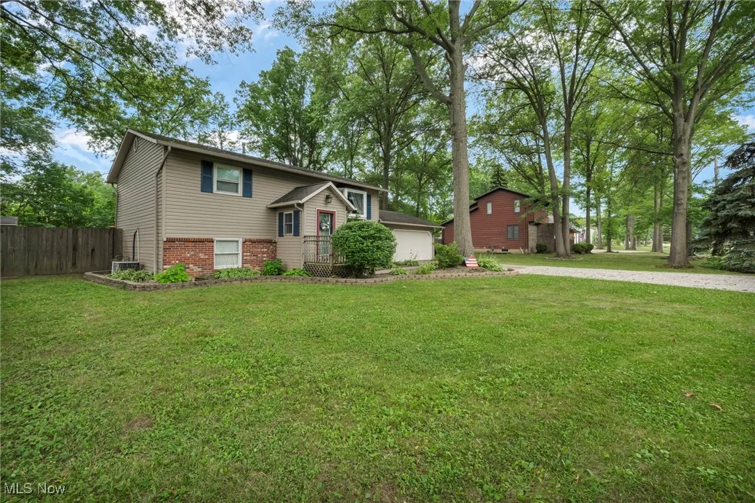 View of front of house featuring brick siding and driveway