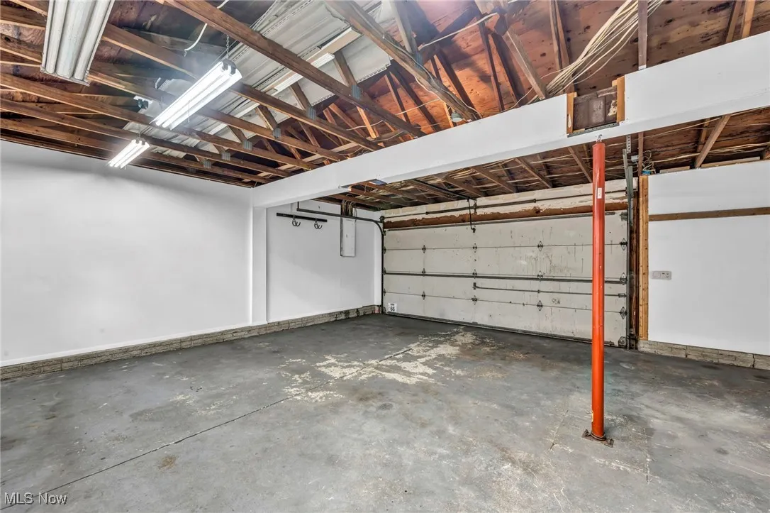 Garage featuring baseboards