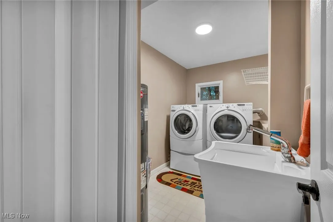 Laundry room featuring independent washer and dryer and tile patterned floors