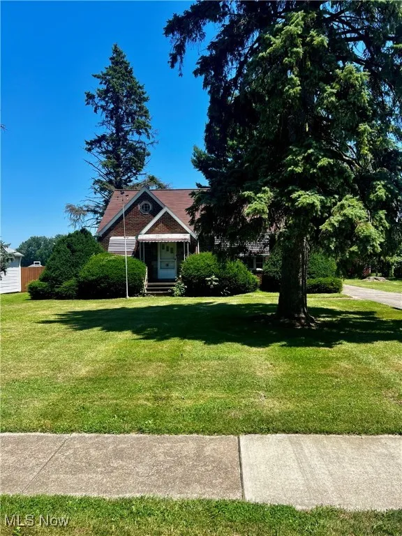 View of front of house featuring a front lawn and sidewalks