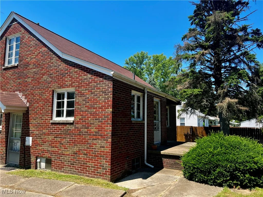 View of brick property exterior and back porch