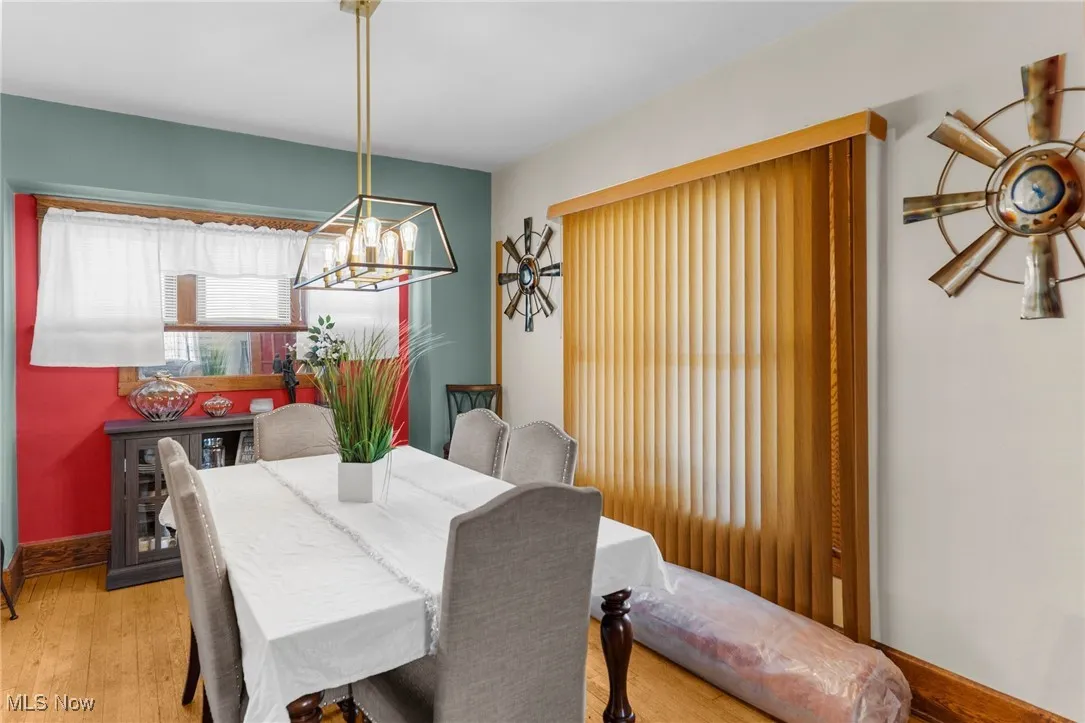 Dining area with a chandelier and light wood-type flooring