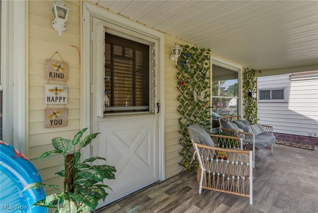 View of exterior entry featuring covered porch
