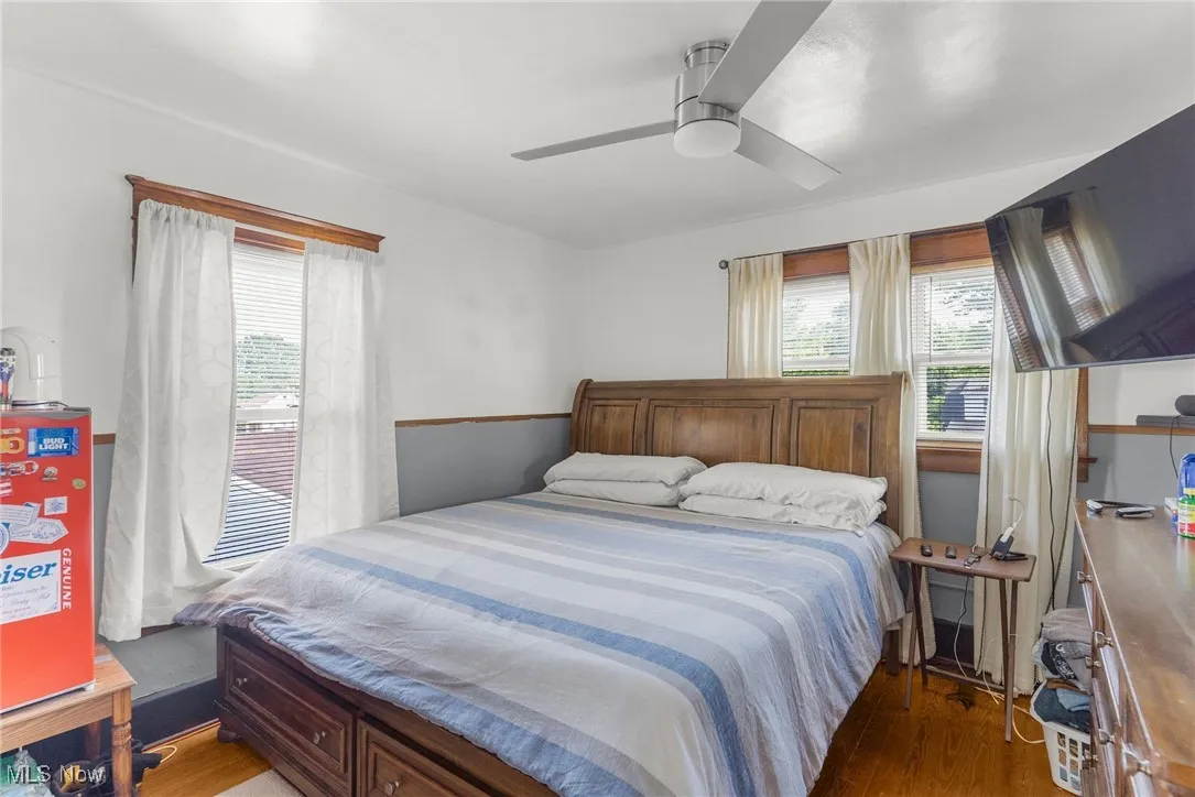 Bedroom with wood finished floors and a ceiling fan