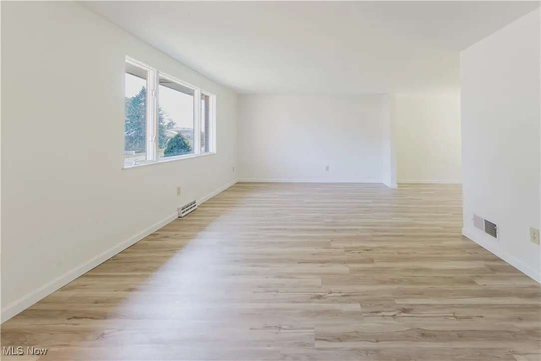 Empty room featuring light wood-style flooring and baseboards