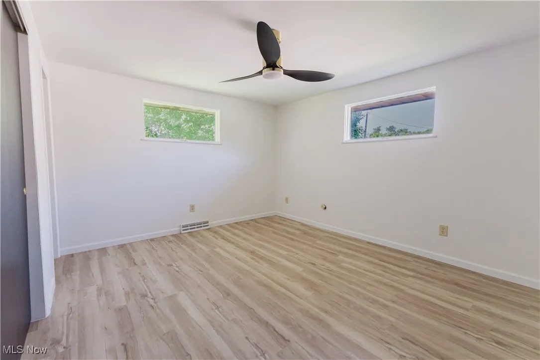 Unfurnished bedroom featuring light wood-style flooring and a ceiling fan