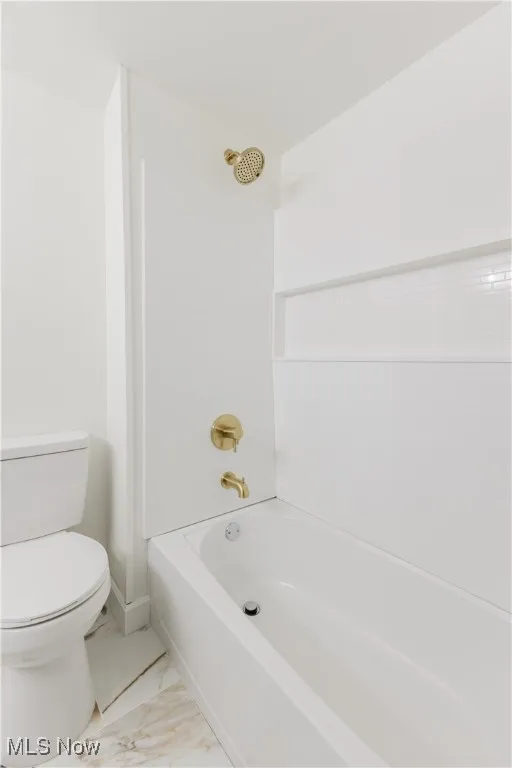 Full bath featuring shower / bathtub combination and marble finish flooring