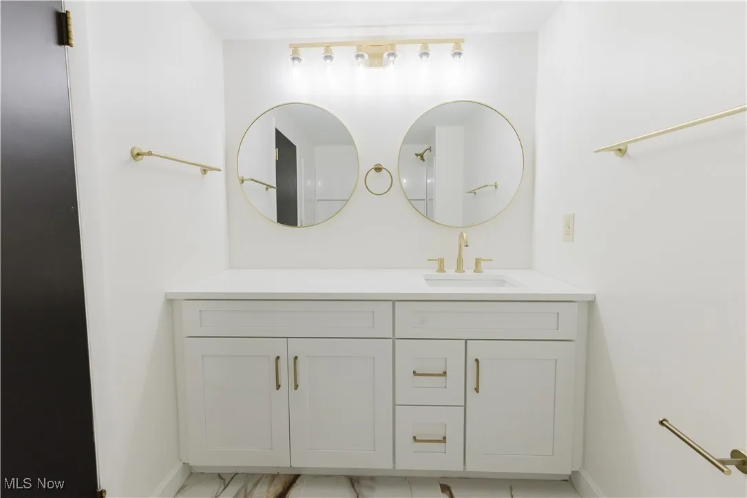 Bathroom featuring vanity and baseboards