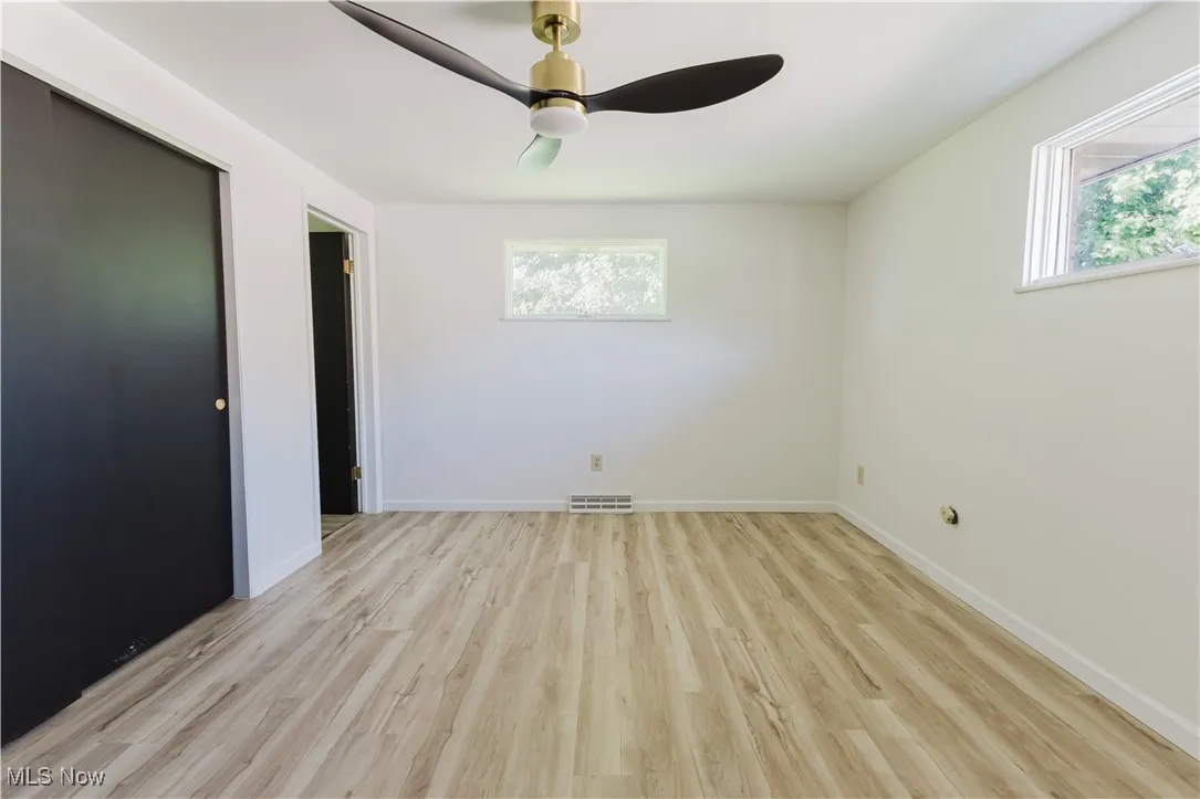 Unfurnished bedroom featuring light wood-style floors and ceiling fan