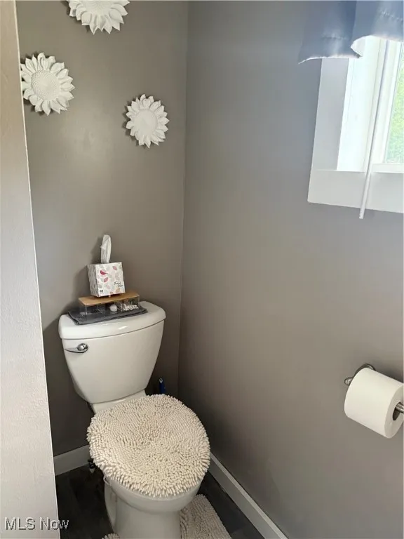Bathroom with baseboards and wood finished floors