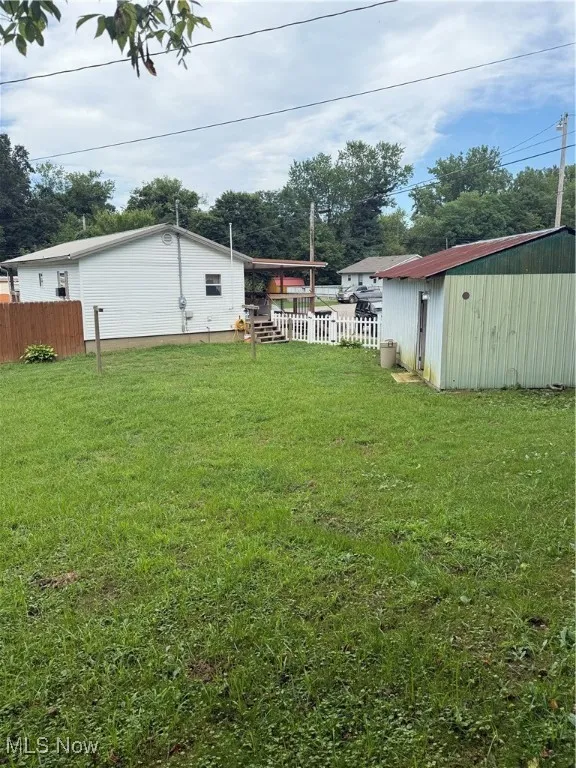 View of yard with an outbuilding