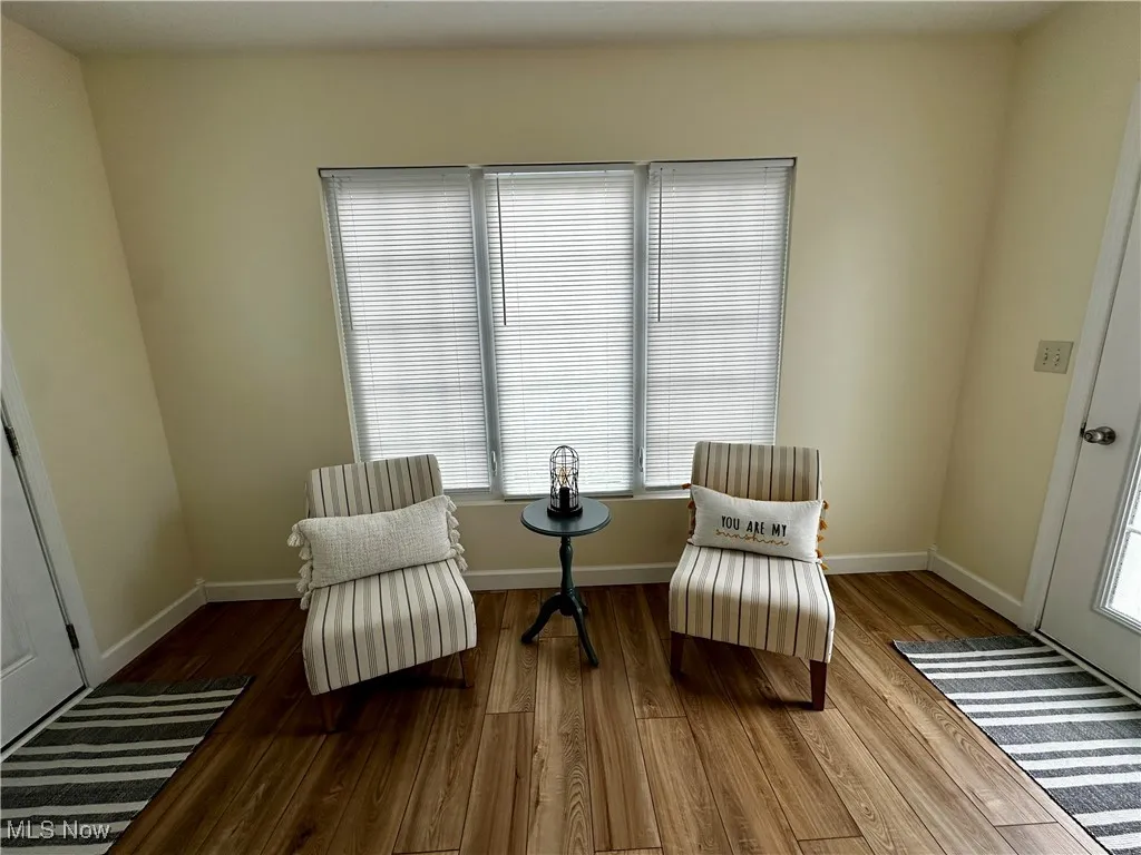 Sitting room featuring wood finished floors and plenty of natural light