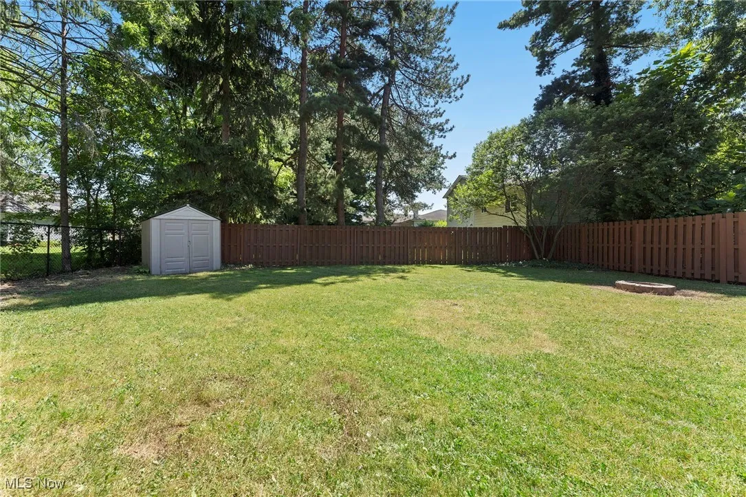 Fenced backyard with a storage unit