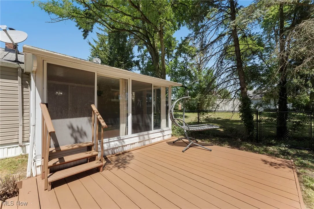 Wooden deck with a sunroom