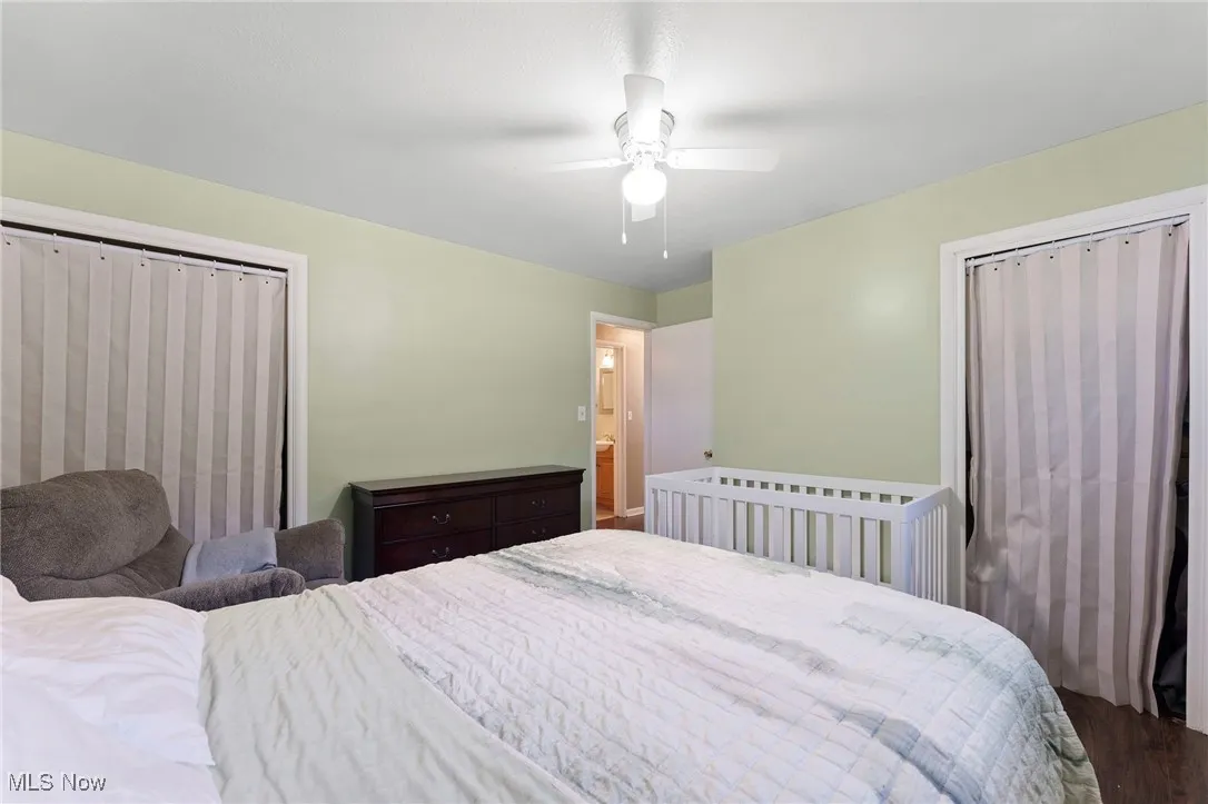 Bedroom with a ceiling fan and wood finished floors