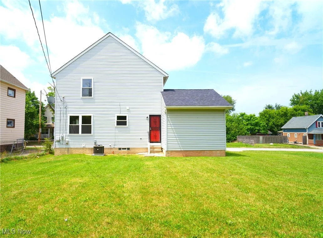 Rear view of house featuring a shingled roof