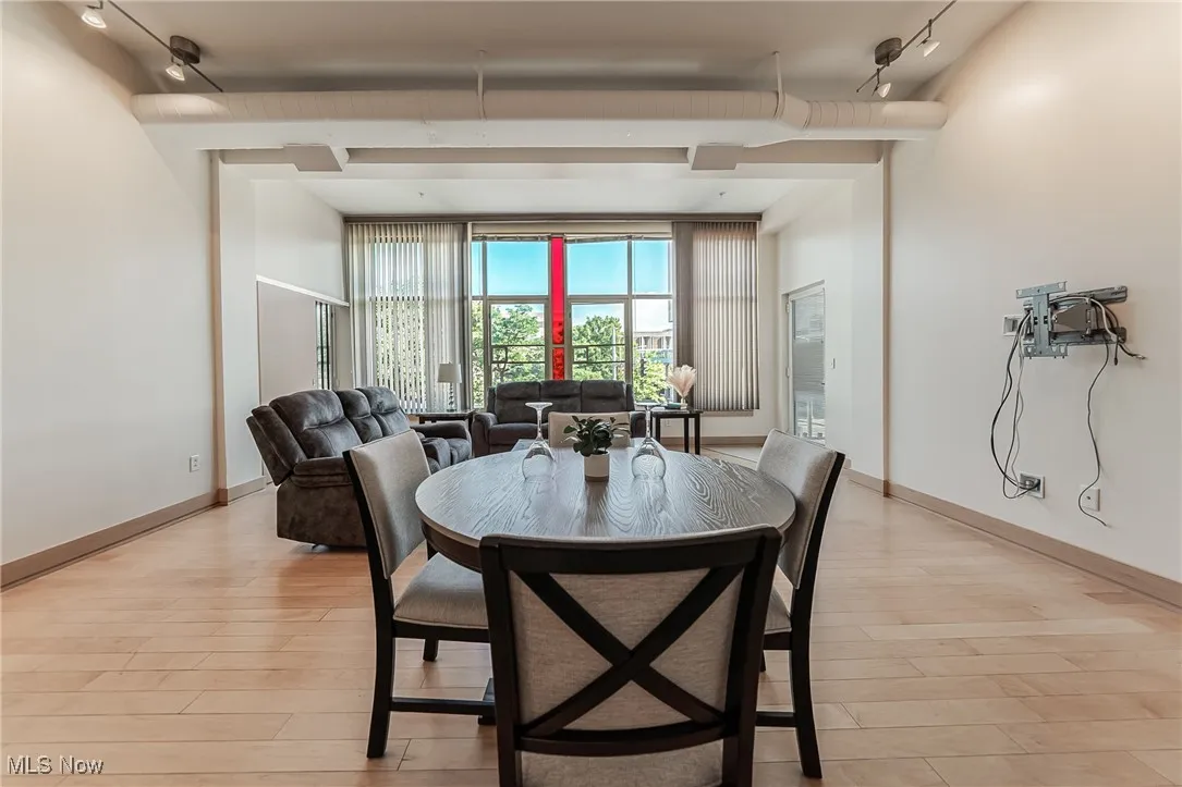 Dining space featuring track lighting and light wood-style flooring.