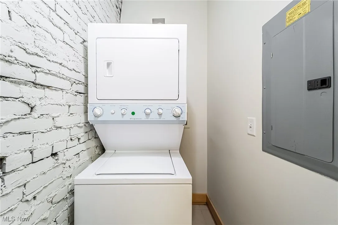 Laundry room with stacked washer / dryer and electric panel