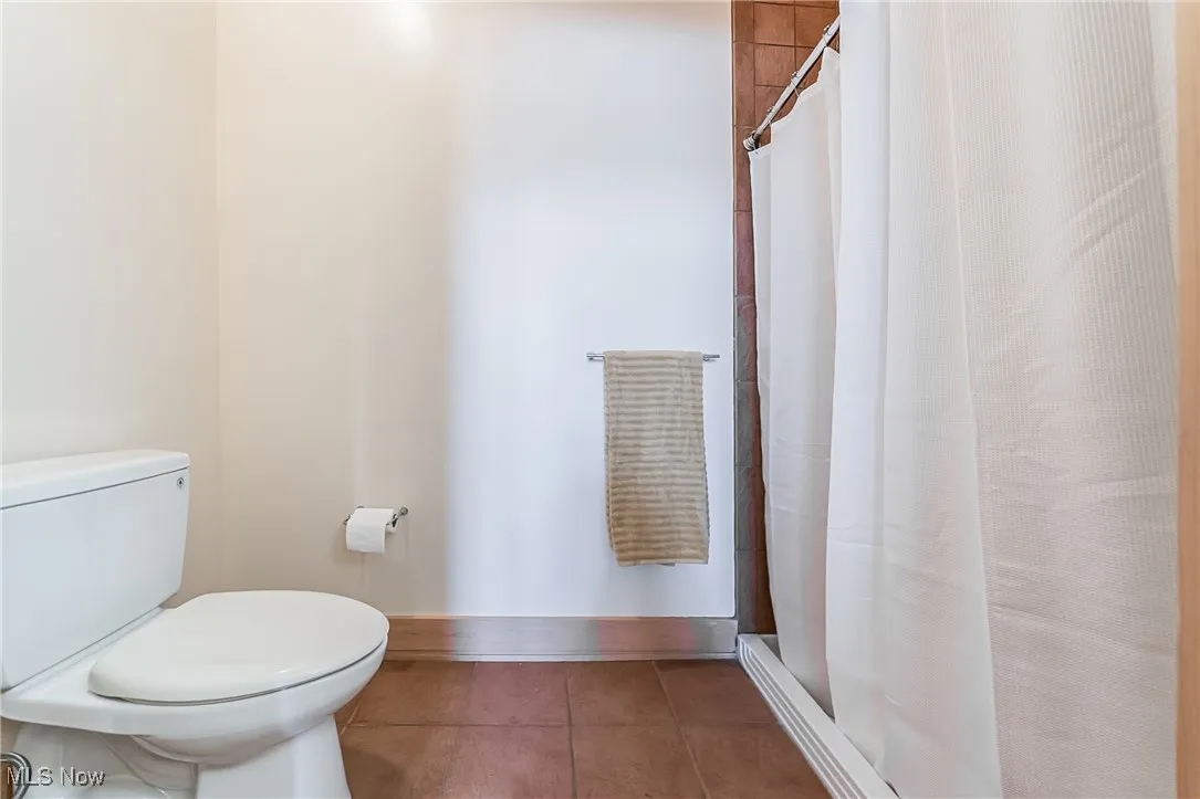 Full bath featuring tile floors and a walk-in shower.