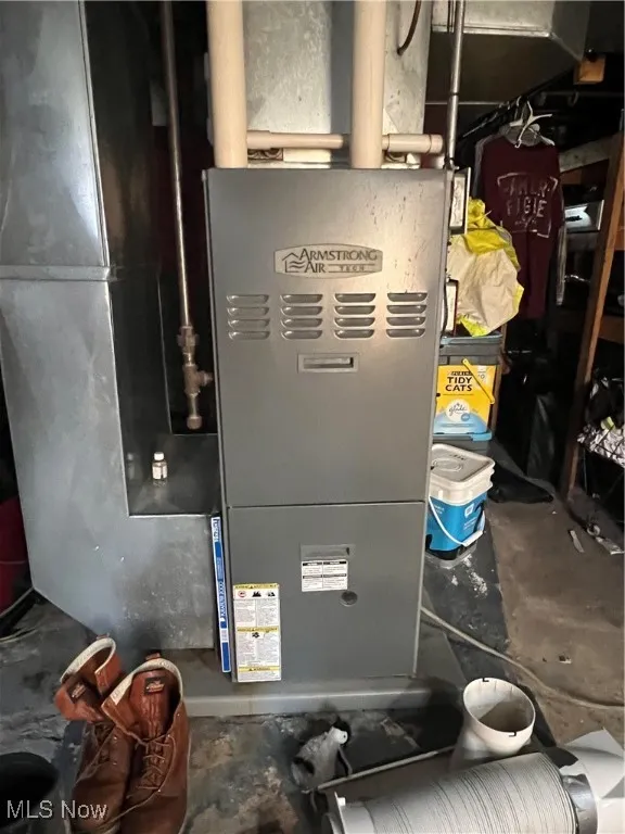Utility room featuring heating unit