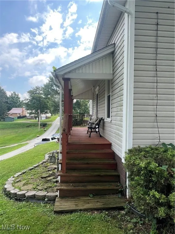 Wooden porch with a lawn