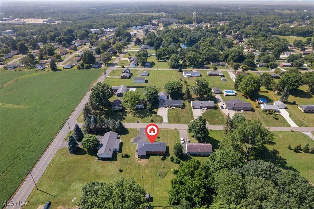 Aerial view of property's location featuring nearby suburban area
