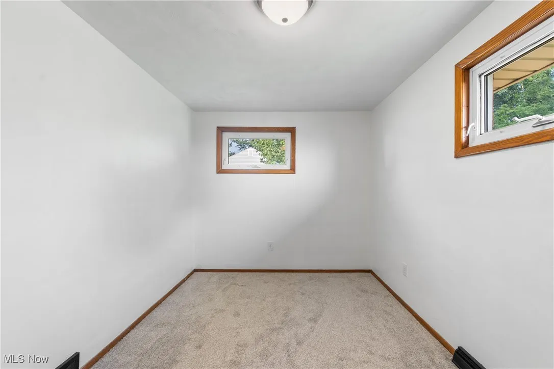 Carpeted empty room with baseboards