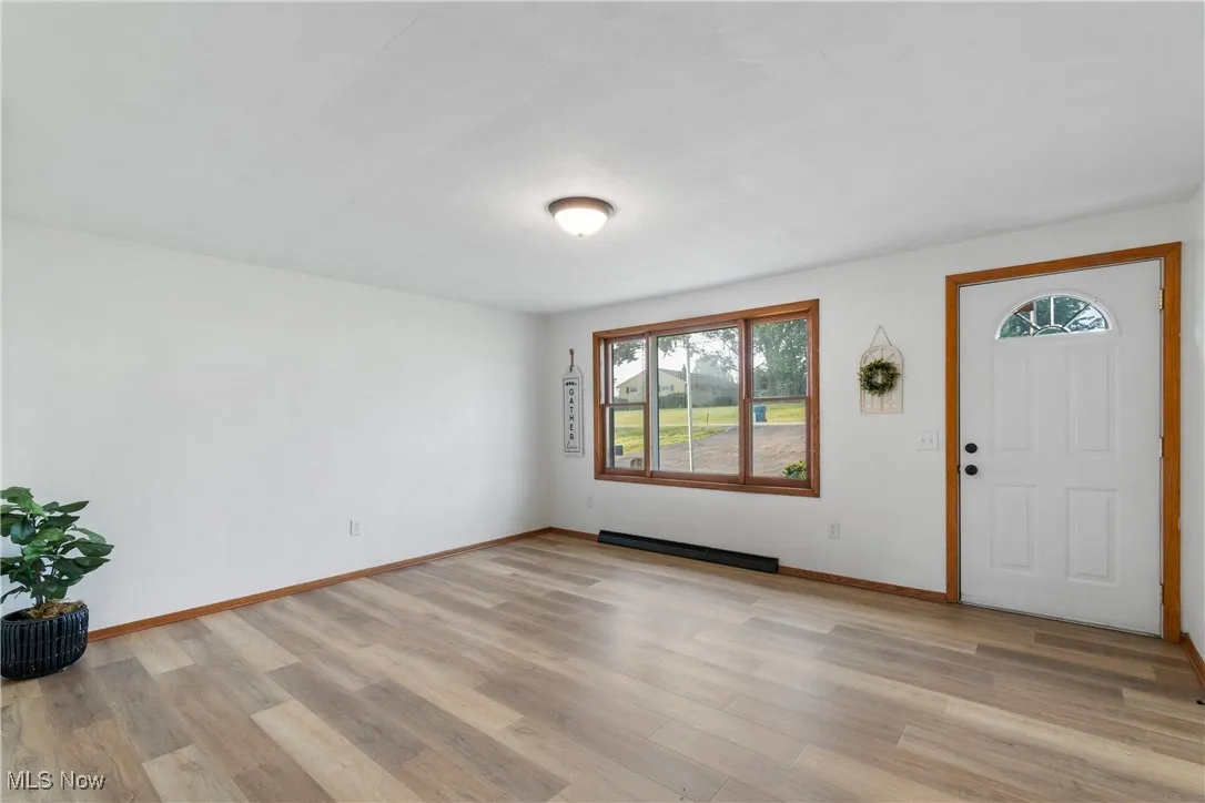 Entryway featuring light wood-style flooring and a baseboard heating unit