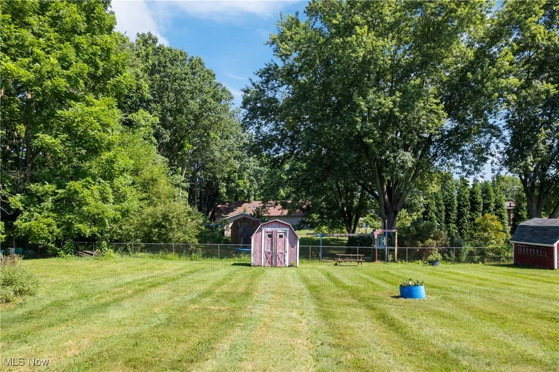 View of yard featuring a storage unit and view of scattered trees