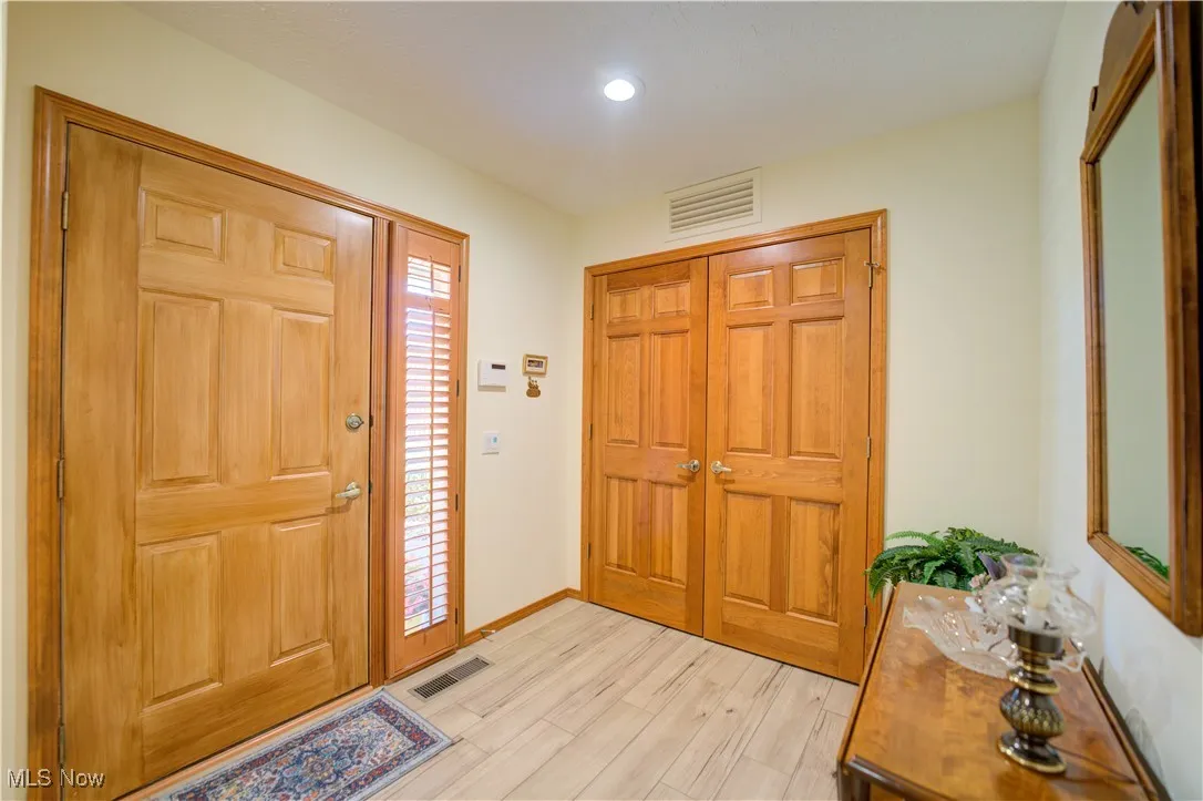 Large entry way with LVT plank flooring and large guest closet.