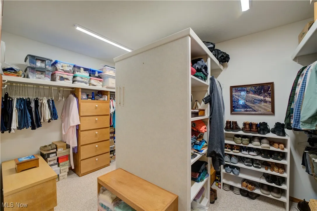 master bedroom with his and her walk-in closet with built in wardrobe chests.