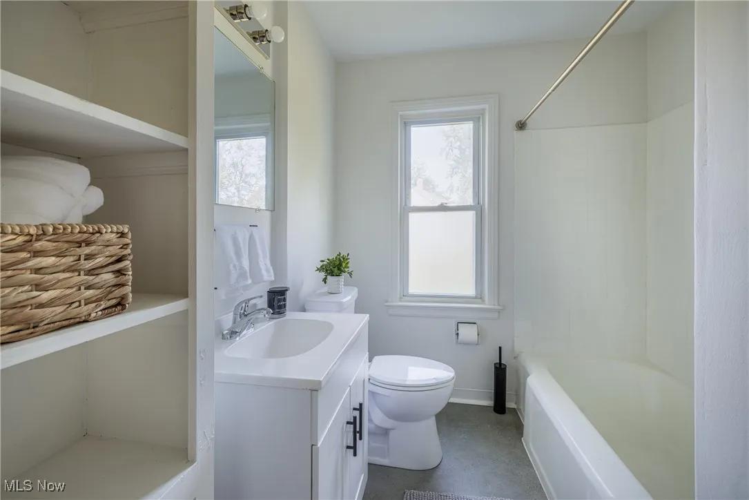 Bathroom featuring vanity and washtub / shower combination